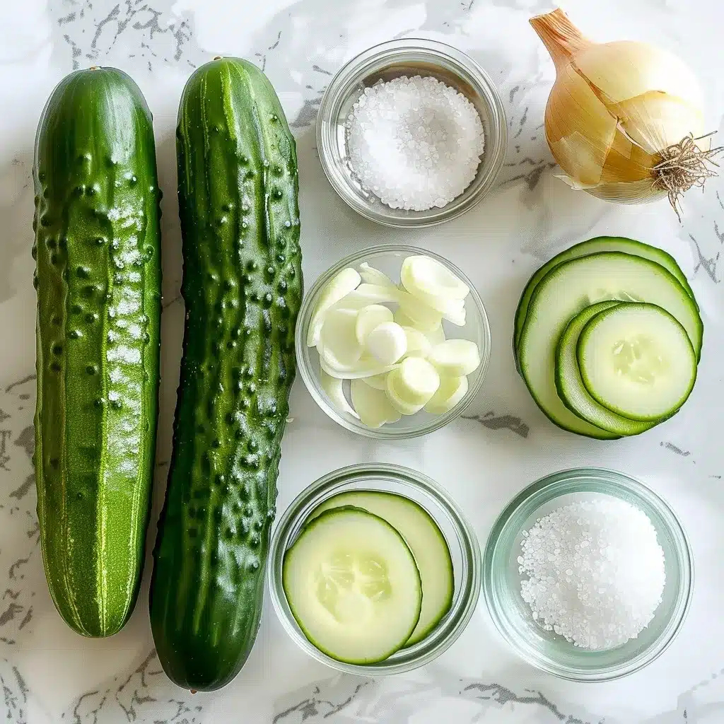 Cucumbers and Onions in Vinegar Recipe: 7 Reasons to Love It 8 Overhead photo of fresh cucumbers, sweet onion, vinegar, water, salt, and sugar arranged on a marble surface.