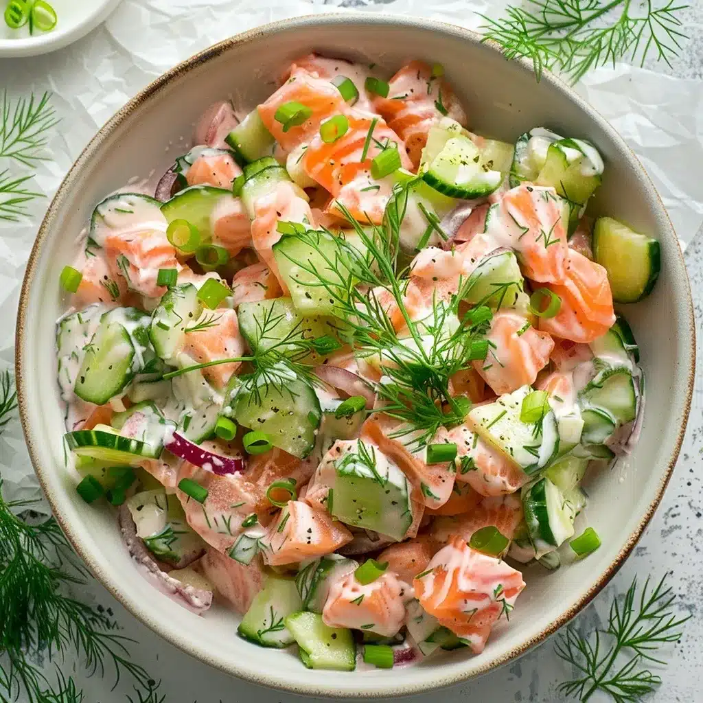 Salmon Cucumber Salad Recipe – The Best 5 Paleo Twists Ever 9 Overhead shot of creamy salmon cucumber salad served in a white bowl, showing flaked salmon, cucumber, dill, and dressing.