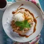 Apple Pie Biscuits Recipe – 7 Cozy Reasons to Bake Now 9 Tasty-style top-down photo of an apple pie biscuit topped with vanilla ice cream and caramel drizzle, served with chai tea.