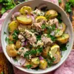 Potato Tuna Salad Recipe: The Best 20-Minute Tangy & Healthy Dish 7 Overhead view of tuna potato salad with parsley, capers, and lemon vinaigrette in a ceramic bowl