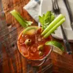 Virgin Bloody Mary Drink Recipe – The Best Bold & Easy Mocktail 7 Virgin Bloody Mary Drink Recipe with garnishes on wooden brunch table